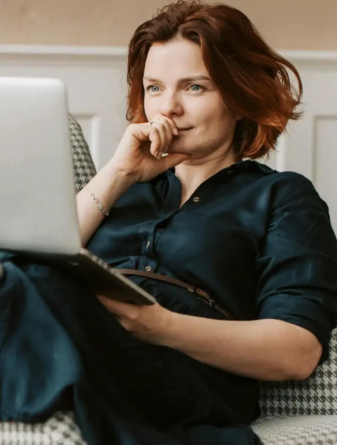 photo of woman looking at laptop screen