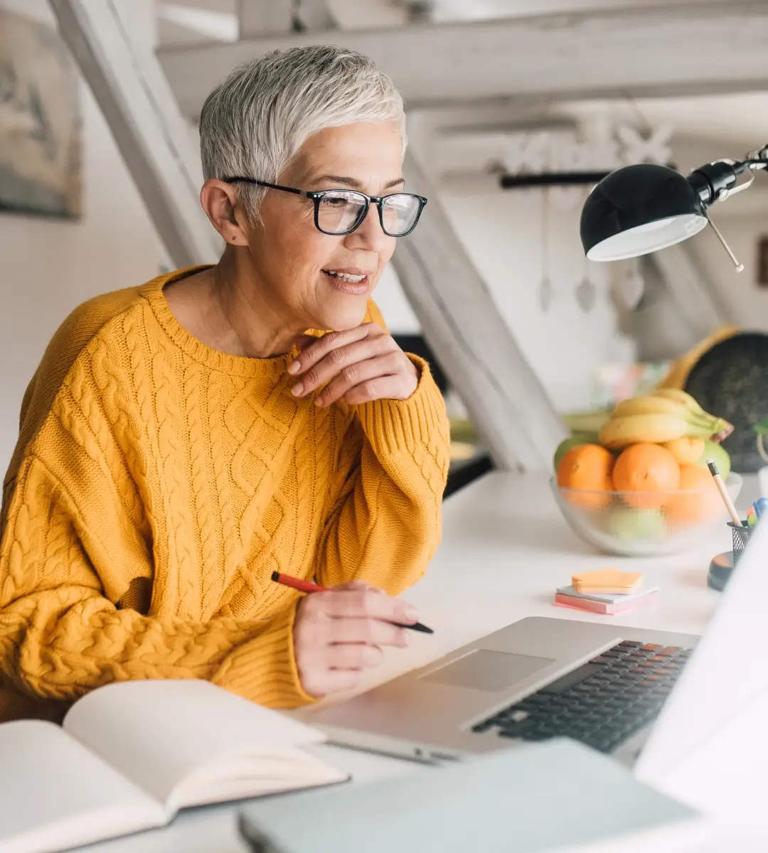 Older woman with glasses using a computer